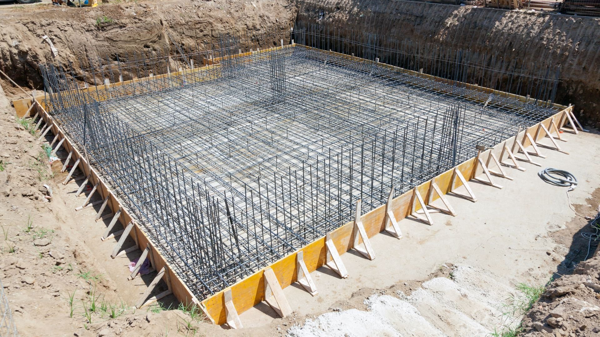 Reinforced steel rebar grid prepared for concrete foundation construction